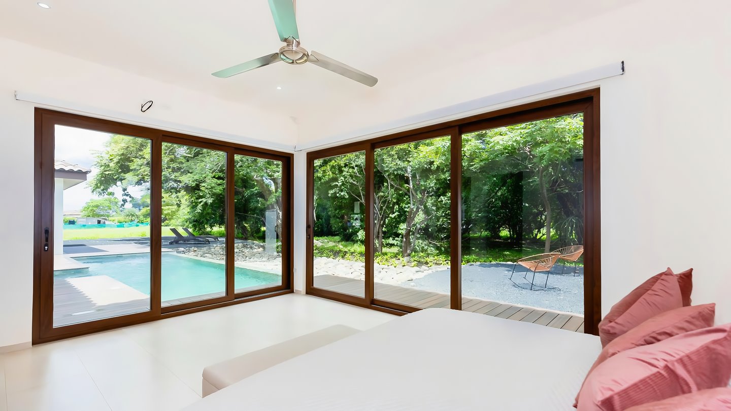10258-The master bedroom with views of the pool and the garden
