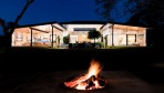 9837-Fire place in the garden with night view of the home